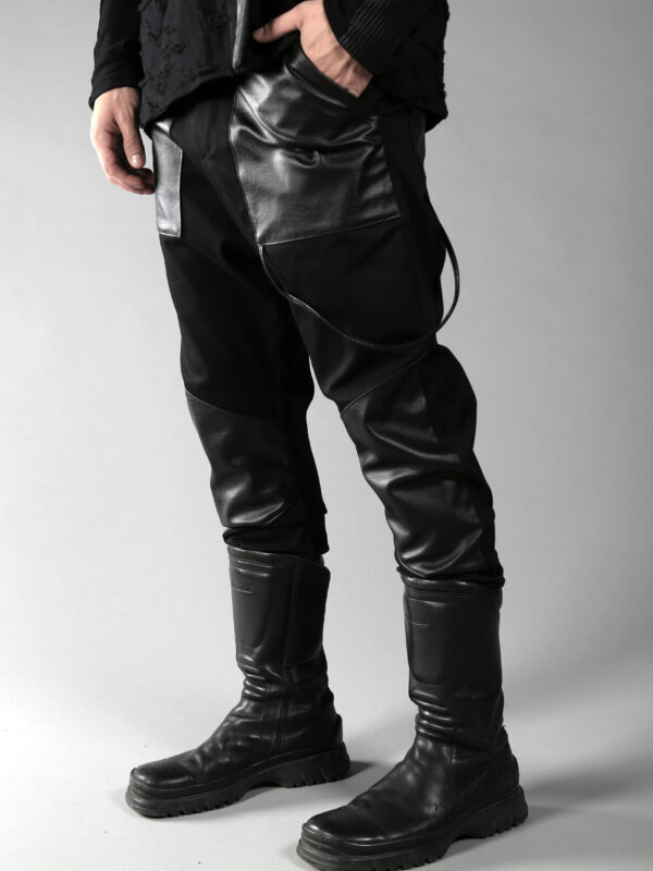 Black denim men pants designed with fake leather pocket on the front, leather pieces on the front lower leg and 2 pockets on back