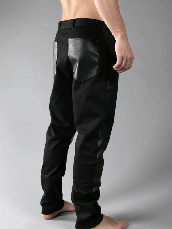 Black denim men pants designed with fake leather pocket on the front, leather pieces on the front lower leg and 2 pockets on back