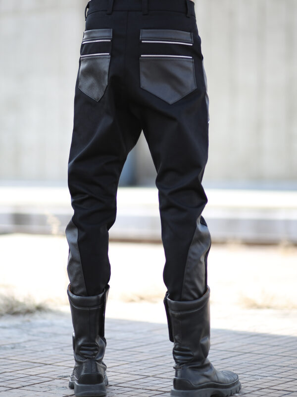 Men Black denim men pants designed with fake leather pocket on the front, leather pieces on the back lower leg and 2 pockets on back.